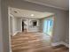 This home's living room has wood flooring with an open view to the kitchen and a backyard slider at 111 D St, Frostproof, FL 33843