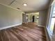 Living room featuring wood-look floors, light gray walls, and white trim at 111 D St, Frostproof, FL 33843