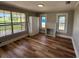 Living room features wood floors, a fireplace, and a large window with natural light at 111 D St, Frostproof, FL 33843