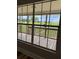 View from the window shows the wooden porch and grass at 111 D St, Frostproof, FL 33843
