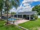 Backyard features a pool with black fencing and a screened porch at 1144 Cephia St, Lake Wales, FL 33853