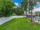 Lush, fenced backyard showcasing green grass and mature trees for privacy at 1144 Cephia St, Lake Wales, FL 33853