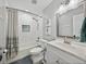 Bright bathroom features a white tiled shower, updated vanity and fixtures, and modern design at 1144 Cephia St, Lake Wales, FL 33853