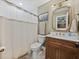 Bathroom featuring wood vanity, tile flooring, and a shower-tub combo at 1144 Cephia St, Lake Wales, FL 33853