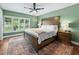 Spacious bedroom with a ceiling fan, wooden furniture and a large window overlooking a yard at 1144 Cephia St, Lake Wales, FL 33853