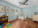 Charming bedroom features a whimsical playhouse bed, wood floors, and a ceiling fan at 1144 Cephia St, Lake Wales, FL 33853