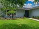Well maintained front yard with lush green grass and professional landscaping, leading to a welcoming front entrance at 1144 Cephia St, Lake Wales, FL 33853
