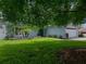 Charming home with a well-manicured lawn, garden beds, and a lovely shade tree at 1144 Cephia St, Lake Wales, FL 33853