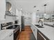 Modern kitchen with white cabinets, subway tile, stainless appliances, and wood floors at 1144 Cephia St, Lake Wales, FL 33853