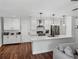 Spacious kitchen with white cabinetry, stainless steel appliances, and wood flooring at 1144 Cephia St, Lake Wales, FL 33853