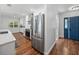 Modern kitchen features stainless steel appliances, white countertops, and a stylish blue front door at 1144 Cephia St, Lake Wales, FL 33853