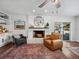 Cozy living room featuring a white brick fireplace and a modern ceiling fan at 1144 Cephia St, Lake Wales, FL 33853