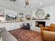 Bright living room with custom built-ins, a brick fireplace, and modern decor at 1144 Cephia St, Lake Wales, FL 33853