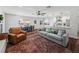 Open concept living space featuring a modern kitchen with stainless steel appliances, and a comfortable seating area with a large rug at 1144 Cephia St, Lake Wales, FL 33853