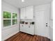 Bright pantry features white cabinets, wood floor, and a window with natural light at 1144 Cephia St, Lake Wales, FL 33853