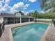 Relaxing backyard pool with screened-in porch and brick patio at 1144 Cephia St, Lake Wales, FL 33853