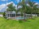 Inviting backyard pool surrounded by lush landscaping, providing a private and serene outdoor oasis for relaxation and enjoyment at 1144 Cephia St, Lake Wales, FL 33853