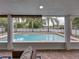 The outdoor space features a lovely pool and serene views beyond the fenced yard at 1144 Cephia St, Lake Wales, FL 33853