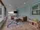 Comfortable screened porch features a brick floor, tv, and a cozy seating area at 1144 Cephia St, Lake Wales, FL 33853