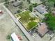 Aerial shot of the property highlighting the homes positioning, tree coverage, and general yard layout at 1351 Smokey Rd, Lake Wales, FL 33859