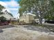 Backyard featuring deck, large shade tree and ample space for vehicles at 1351 Smokey Rd, Lake Wales, FL 33859
