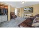 Finished basement with closet space, wood look tile flooring, and a large TV at 1351 Smokey Rd, Lake Wales, FL 33859