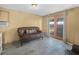 Finished basement with stylish tile flooring, cozy seating, and access to the backyard at 1351 Smokey Rd, Lake Wales, FL 33859