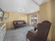 Finished basement with stylish tile flooring, cozy seating, and access to the backyard at 1351 Smokey Rd, Lake Wales, FL 33859