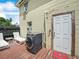 Exterior view of the home with a small deck and laundry machines, showcasing functional outdoor space at 1351 Smokey Rd, Lake Wales, FL 33859