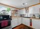 Bright kitchen featuring butcher block countertops, white cabinets and stainless appliances at 1351 Smokey Rd, Lake Wales, FL 33859