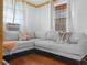 Bright living room featuring a comfortable sectional couch, colorful pillows, and window with curtains at 1351 Smokey Rd, Lake Wales, FL 33859