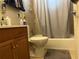 Functional bathroom featuring a bathtub with shower, tiled walls, and a storage vanity at 1422 Avenue H Sw, Winter Haven, FL 33880