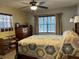 Comfortable bedroom featuring a bed, dresser, and a large window with curtains for natural light at 1422 Avenue H Sw, Winter Haven, FL 33880