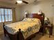 Inviting bedroom with a bed, sconce lighting, side tables, and a window dressed with curtains at 1422 Avenue H Sw, Winter Haven, FL 33880