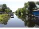 A picturesque canal view with docks, boats, and lush trees along the waterfront at 1422 Avenue H Sw, Winter Haven, FL 33880