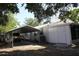 A covered carport next to the home features a metal roof and ample space for parking vehicles at 1422 Avenue H Sw, Winter Haven, FL 33880