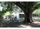 The exterior of the property shows a carport, trailer, and well-maintained yard with mature trees at 1422 Avenue H Sw, Winter Haven, FL 33880