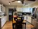 Bright kitchen with white cabinets, stainless steel appliances, and hardwood flooring at 1422 Avenue H Sw, Winter Haven, FL 33880