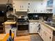 Updated kitchen with stainless steel appliances, granite countertops, and custom backsplash at 1422 Avenue H Sw, Winter Haven, FL 33880