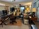 Cozy living room featuring comfortable seating, a ceiling fan, and unique guitar decor at 1422 Avenue H Sw, Winter Haven, FL 33880