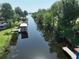 Aerial view of a waterway with docks, boathouses, and lush green trees lining the banks at 1422 Avenue H Sw, Winter Haven, FL 33880