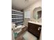Well-lit bathroom with a large vanity, decorative mirror and a tub with shower at 1885 Pfundstein Rd, Babson Park, FL 33827