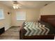 Cozy bedroom with wood-look floors and a large window for natural light at 1885 Pfundstein Rd, Babson Park, FL 33827