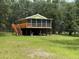 Charming home featuring a screened porch, elevated design, and a tranquil wooded setting at 1885 Pfundstein Rd, Babson Park, FL 33827