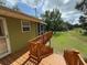 Elevated wooden deck and stairway lead to the house, showcasing the natural surroundings at 1885 Pfundstein Rd, Babson Park, FL 33827