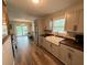Bright kitchen with wooden countertops and farmhouse-style sink overlooking the living space at 1885 Pfundstein Rd, Babson Park, FL 33827