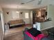 Relaxing living area featuring wood floors and views of the kitchen area at 1885 Pfundstein Rd, Babson Park, FL 33827