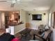 Cozy living room featuring wood-style floors, television, and open to the kitchen at 1885 Pfundstein Rd, Babson Park, FL 33827