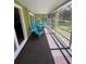 Relaxing screened porch with comfortable blue chairs and views of the outdoors at 1885 Pfundstein Rd, Babson Park, FL 33827