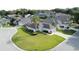An aerial view of a home showcasing its well-manicured lawn in a friendly residential neighborhood at 2200 Mallory Cir, Haines City, FL 33844